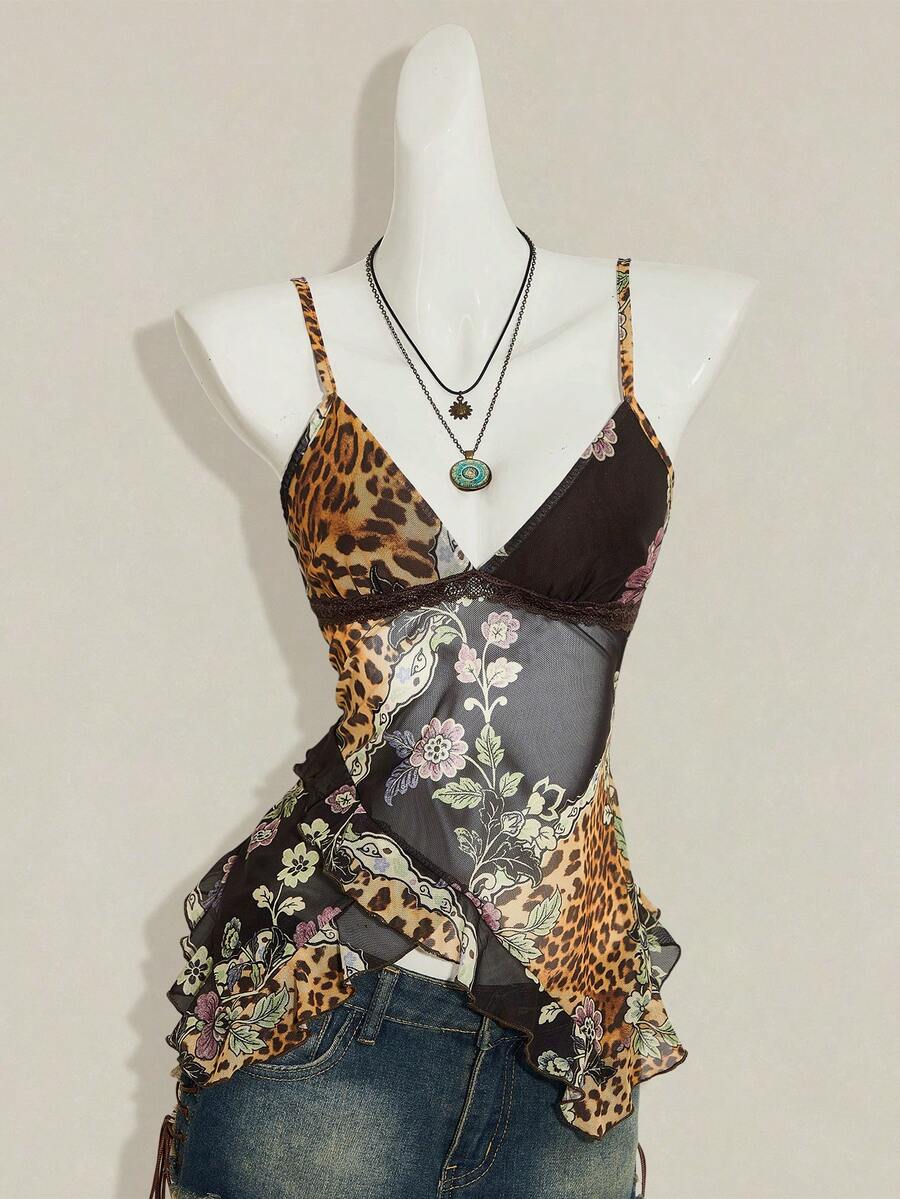 Women's graphic print camisole top featuring thin spaghetti straps, a backless cut, and an asymmetrical hem.