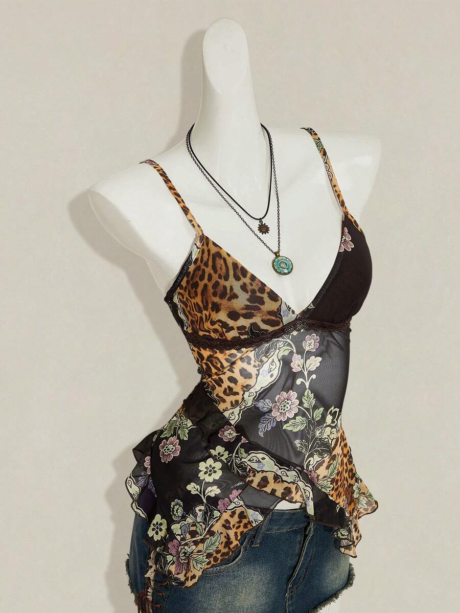 Women's graphic print camisole top featuring thin spaghetti straps, a backless cut, and an asymmetrical hem.