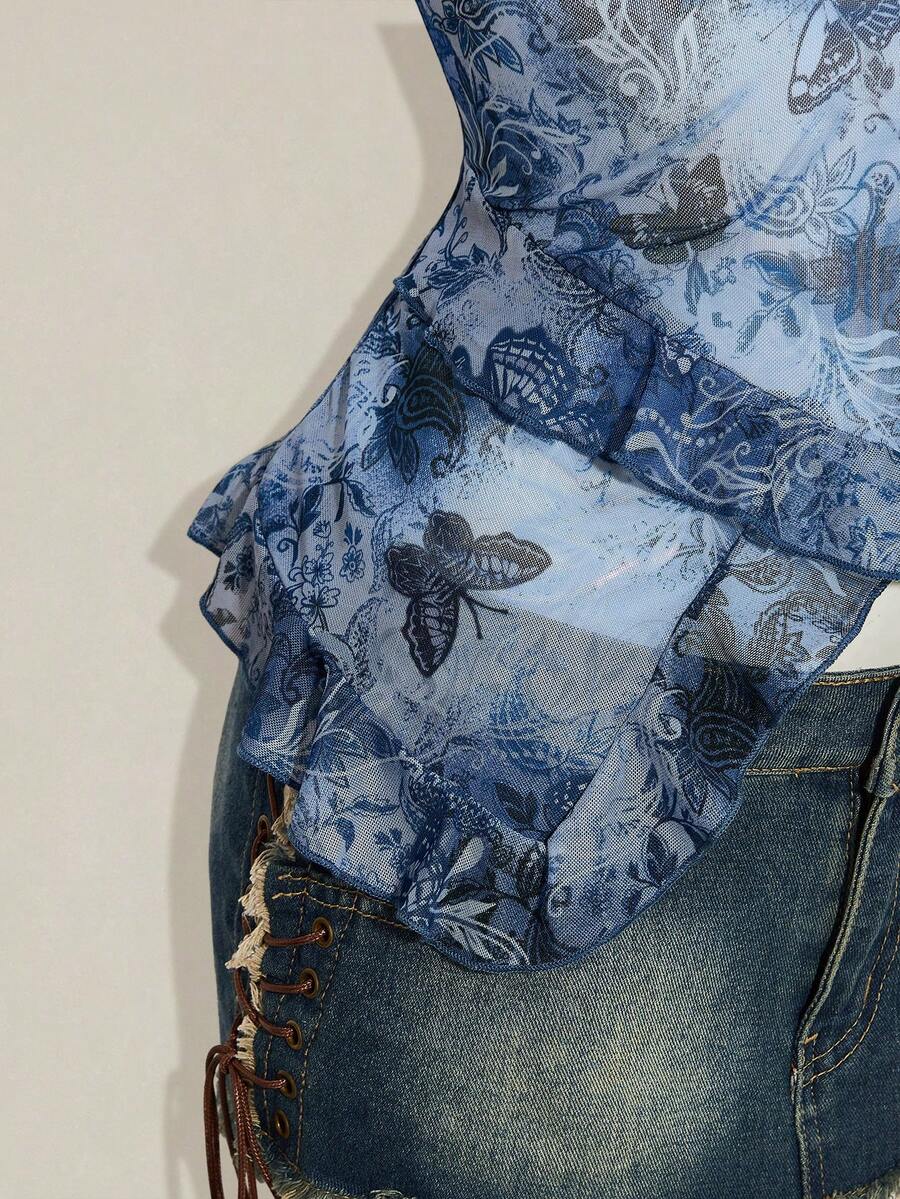 Women's graphic print camisole top featuring thin spaghetti straps, a backless cut, and an asymmetrical hem.