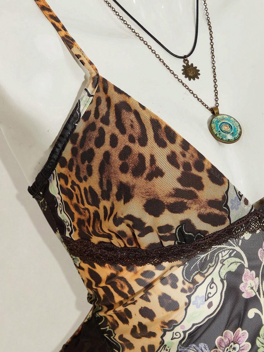 Women's graphic print camisole top featuring thin spaghetti straps, a backless cut, and an asymmetrical hem.