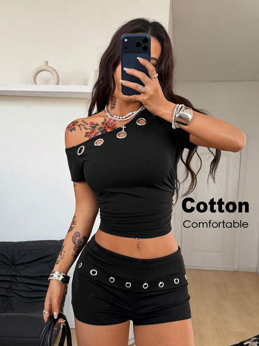 Women's black ultra low rise mini shorts with grommet eyelet and rib-knit details, zipper fly closure, skinny straight-leg fit, and plain knitted fabric.