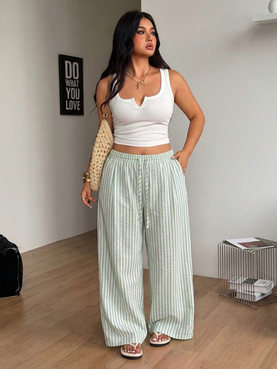 Plus size women's striped loose straight leg cropped pants with pleated detailing and side pockets