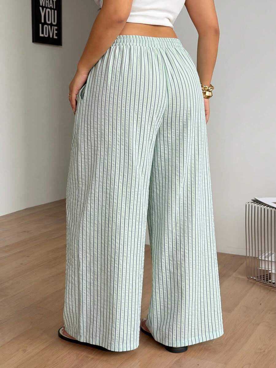 Plus size women's striped loose straight leg cropped pants with pleated detailing and side pockets