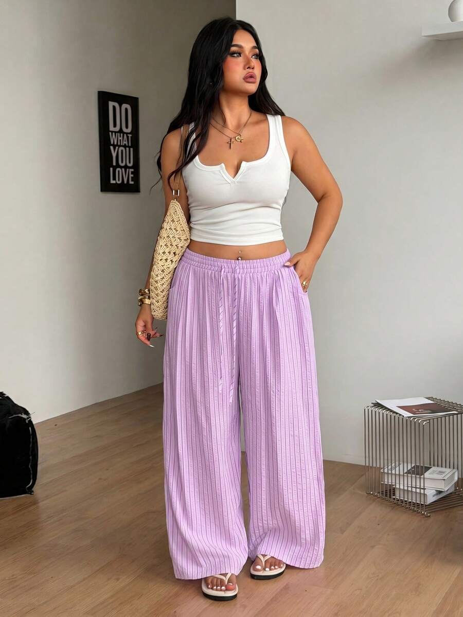 Plus size women's striped loose straight leg cropped pants with pleated detailing and side pockets
