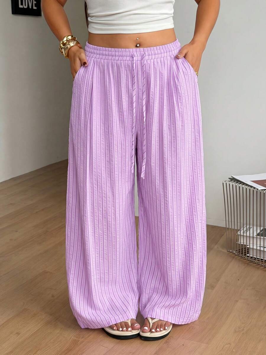 Plus size women's striped loose straight leg cropped pants with pleated detailing and side pockets