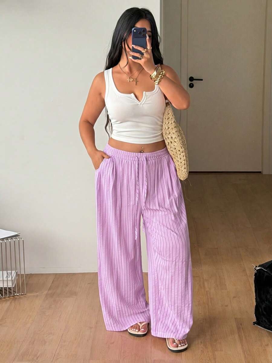 Plus size women's striped loose straight leg cropped pants with pleated detailing and side pockets