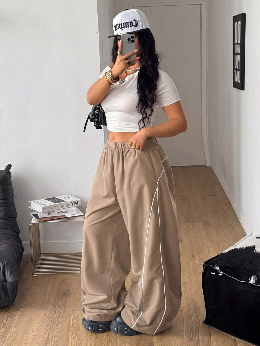Plus size loose straight leg casual pants with elastic drawstring waist, contrast binding, and side pockets.