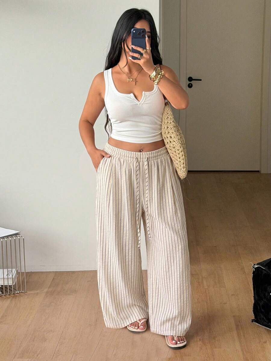 Plus size women's striped loose straight leg cropped pants with pleated detailing and side pockets