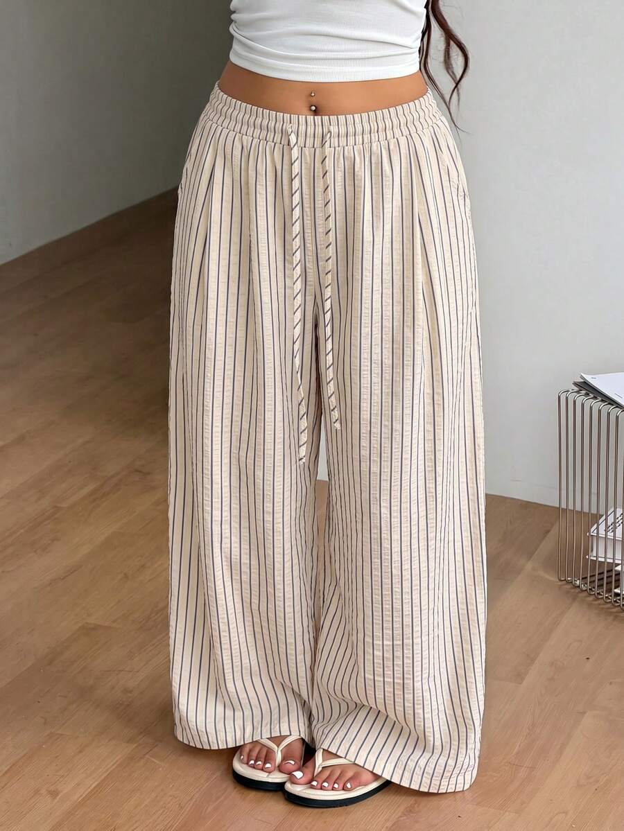 Plus size women's striped loose straight leg cropped pants with pleated detailing and side pockets