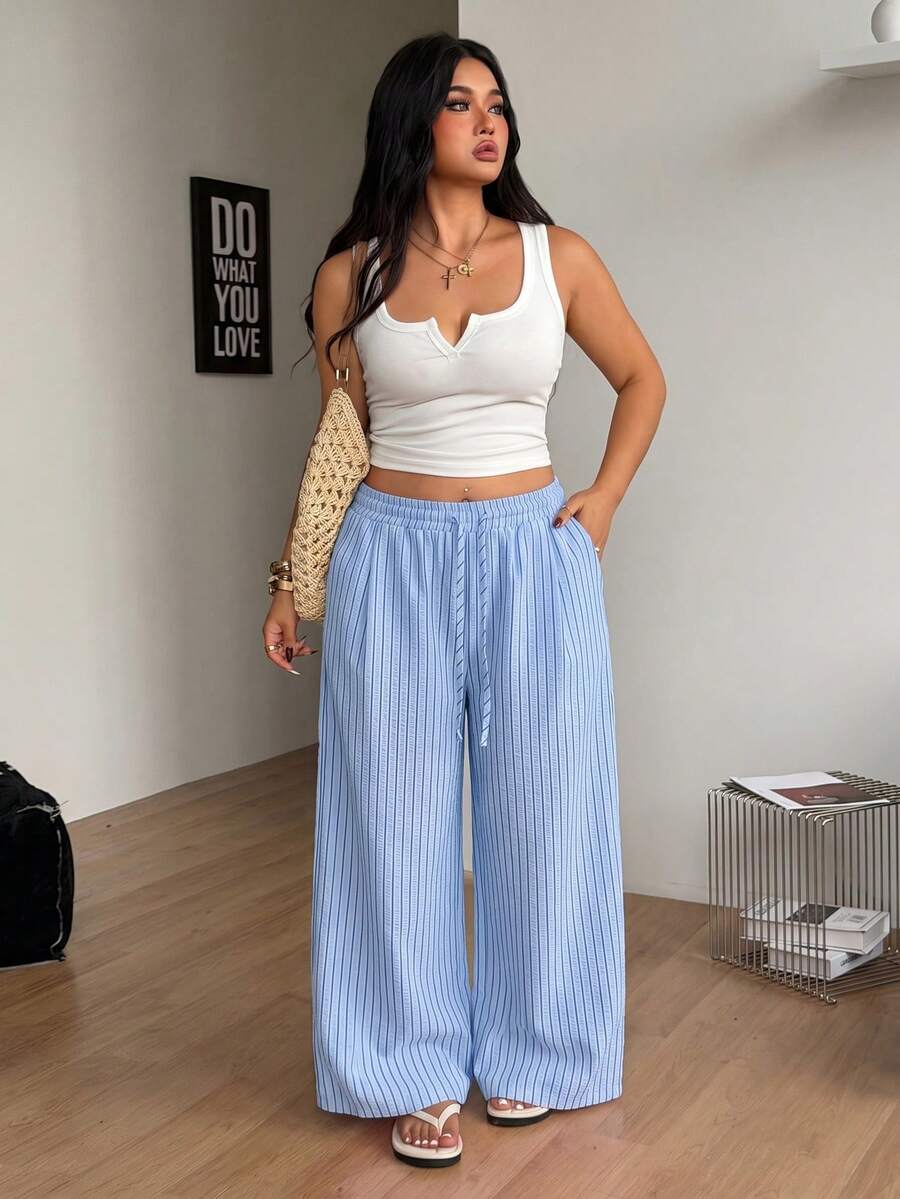 Plus size women's striped loose straight leg cropped pants with pleated detailing and side pockets