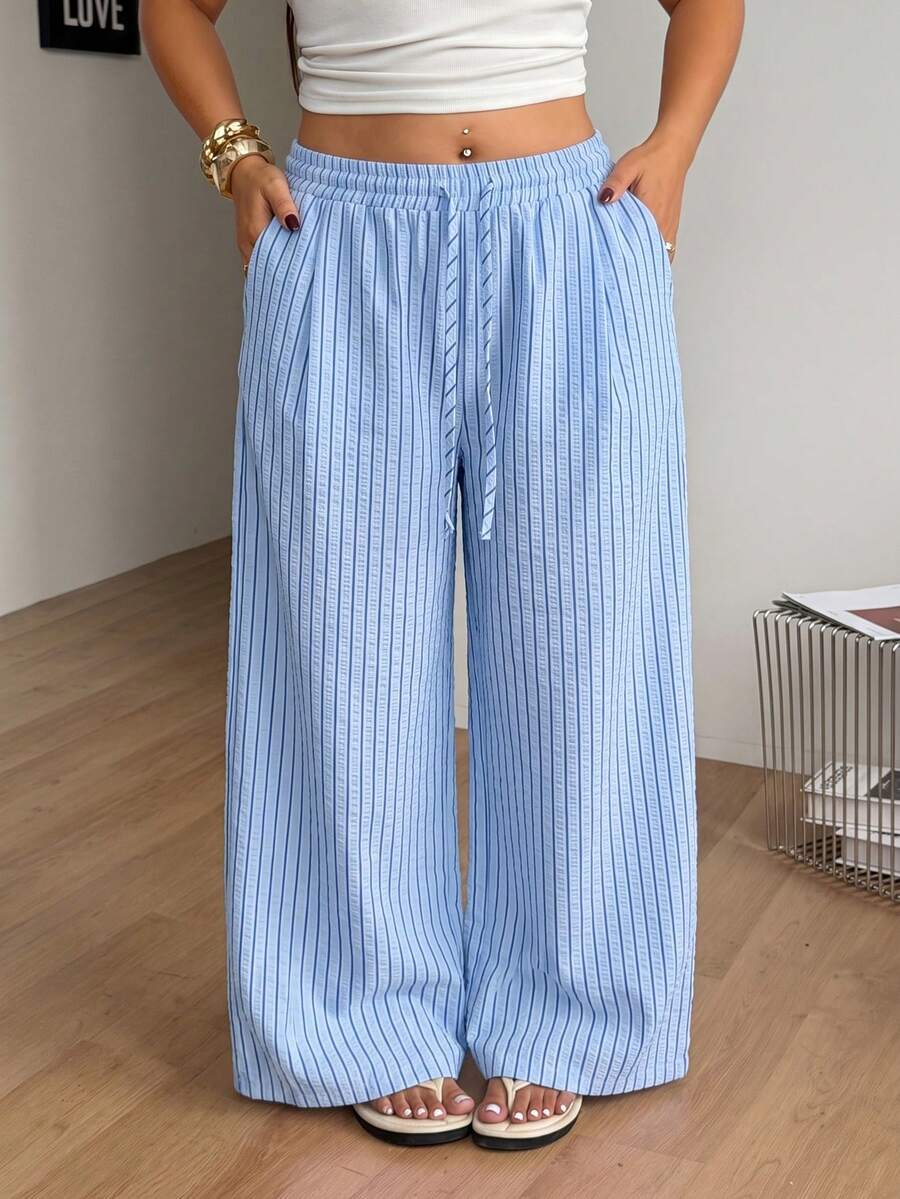 Plus size women's striped loose straight leg cropped pants with pleated detailing and side pockets