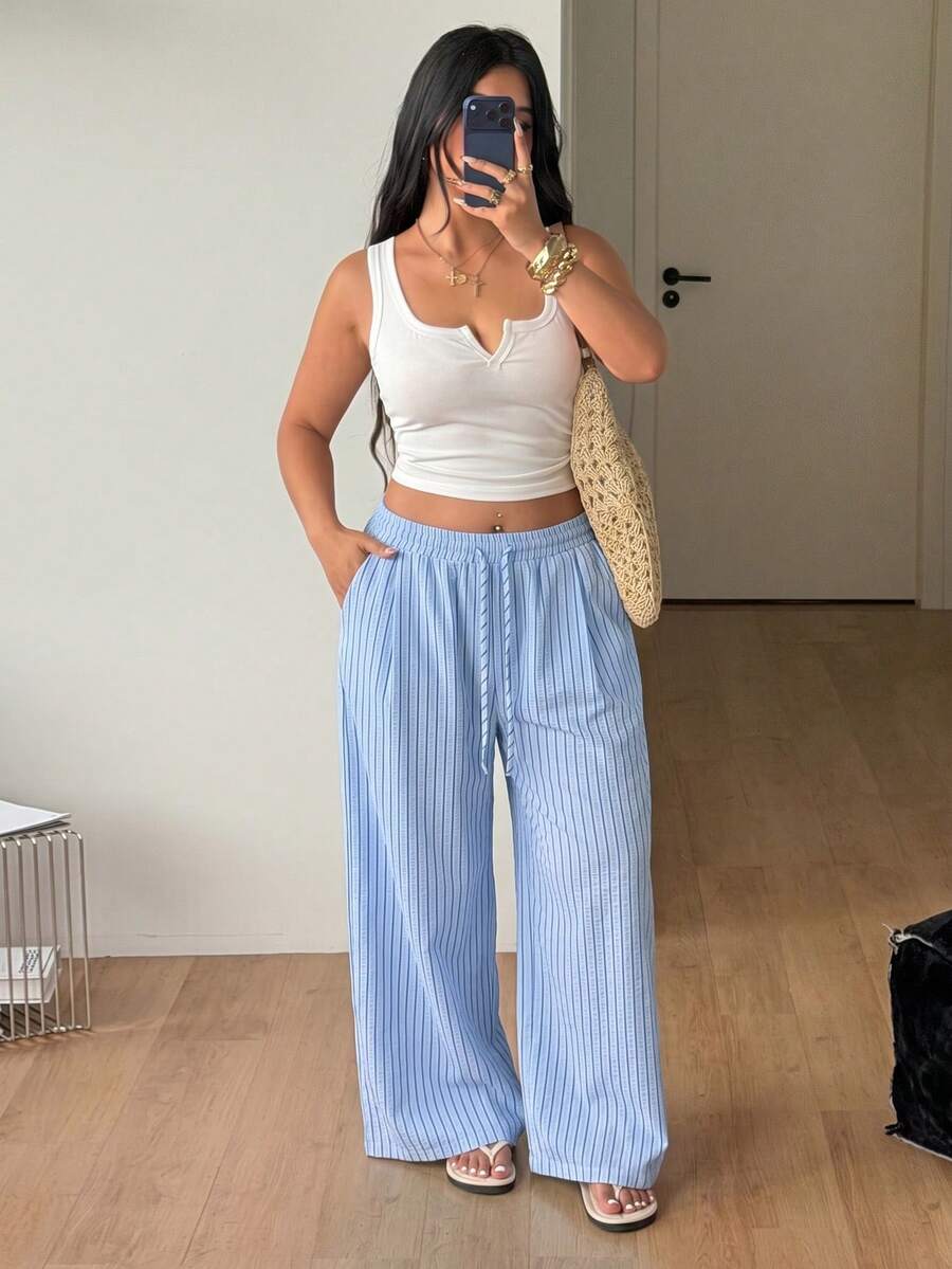 Plus size women's striped loose straight leg cropped pants with pleated detailing and side pockets