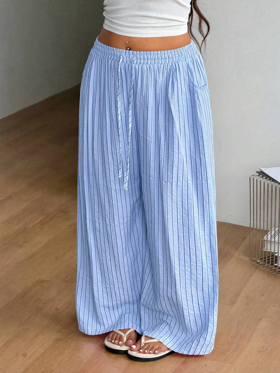Plus size women's striped loose straight leg cropped pants with pleated detailing and side pockets