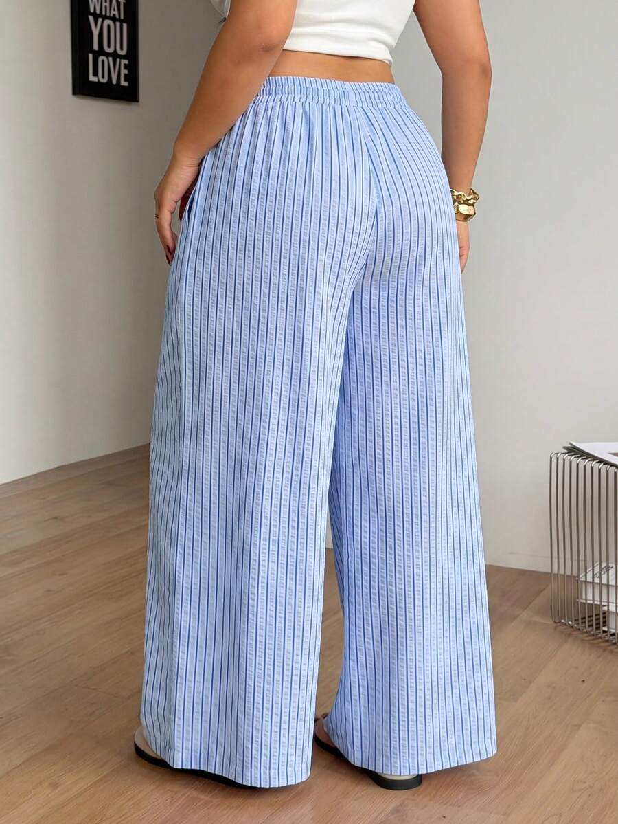 Plus size women's striped loose straight leg cropped pants with pleated detailing and side pockets
