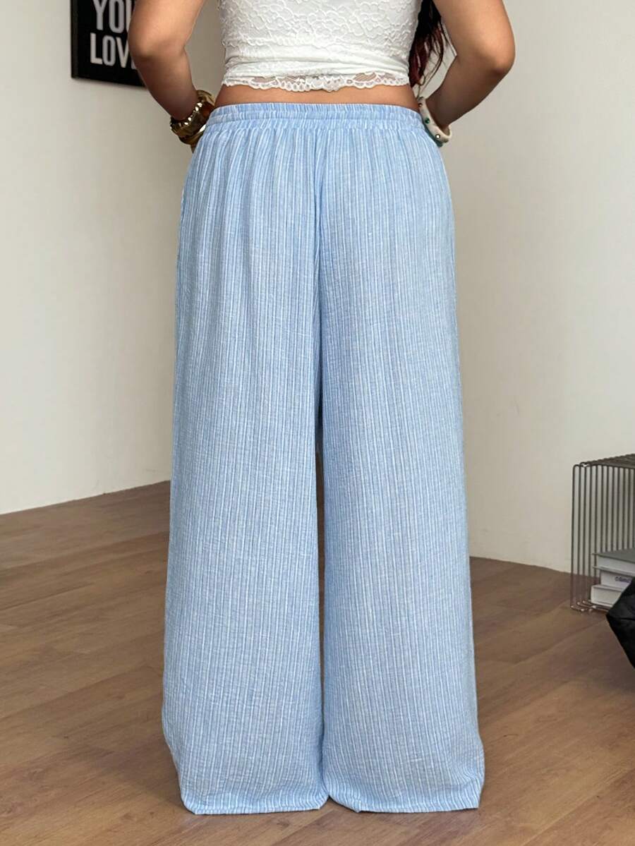 Women's loose straight leg cotton pants featuring a high waist with an adjustable drawstring knot and functional side pockets.