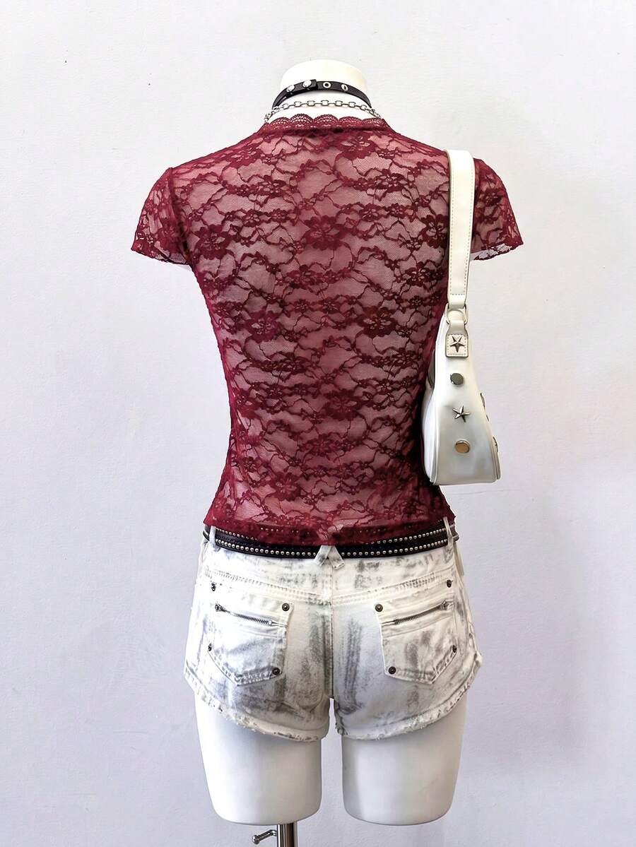 Women's semi-sheer deep V-neck top featuring cap sleeves, contrast lace trimming, and a lace-up front detail.