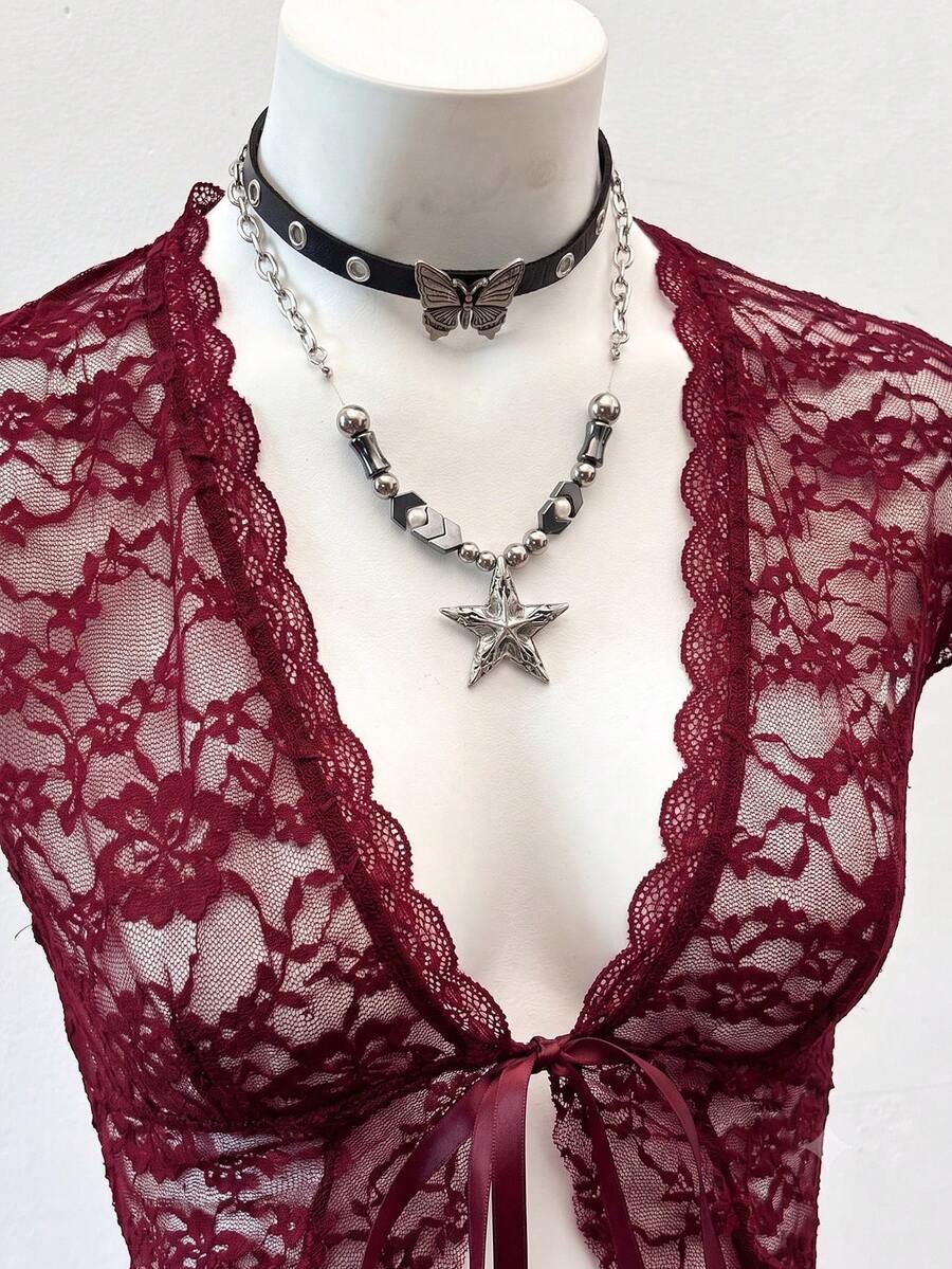 Women's semi-sheer deep V-neck top featuring cap sleeves, contrast lace trimming, and a lace-up front detail.