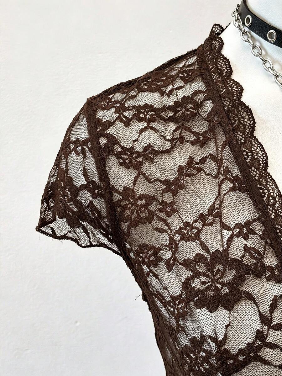 Women's semi-sheer deep V-neck top featuring cap sleeves, contrast lace trimming, and a lace-up front detail.