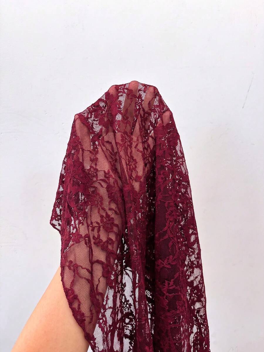 Women's semi-sheer deep V-neck top featuring cap sleeves, contrast lace trimming, and a lace-up front detail.