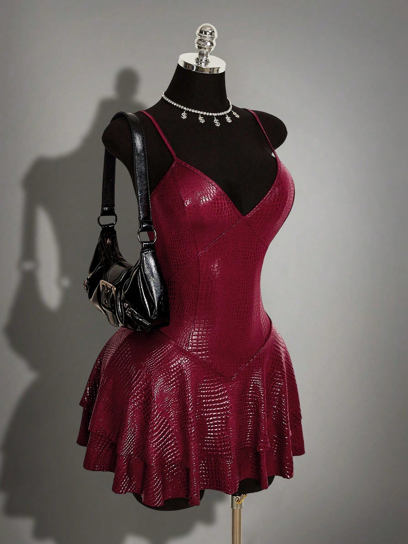 Women's Y2K PU leather mini dress with spaghetti straps, V-neckline, backless design, zipper closure, high waist, slim A-line fit, and layered tiered hem.