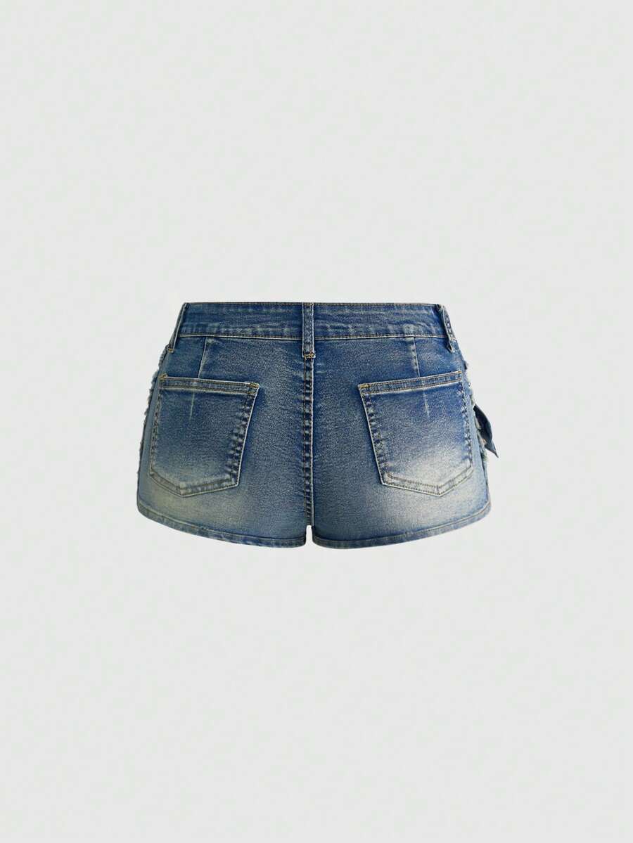 Black grunge punk low-waist mini shorts with studded details and zipper fly closure