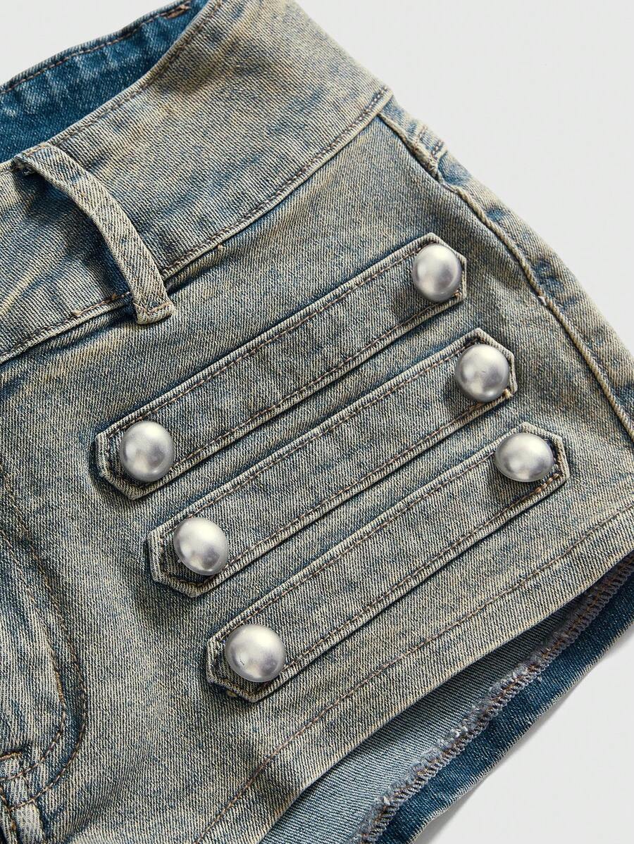 Front view of women's ultra low waist denim mini shorts with double metal button accents and zipper fly