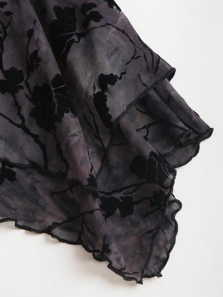 Women's black spaghetti strap tank top featuring contrast lace details, asymmetric ruffle hem, and slim fit design.