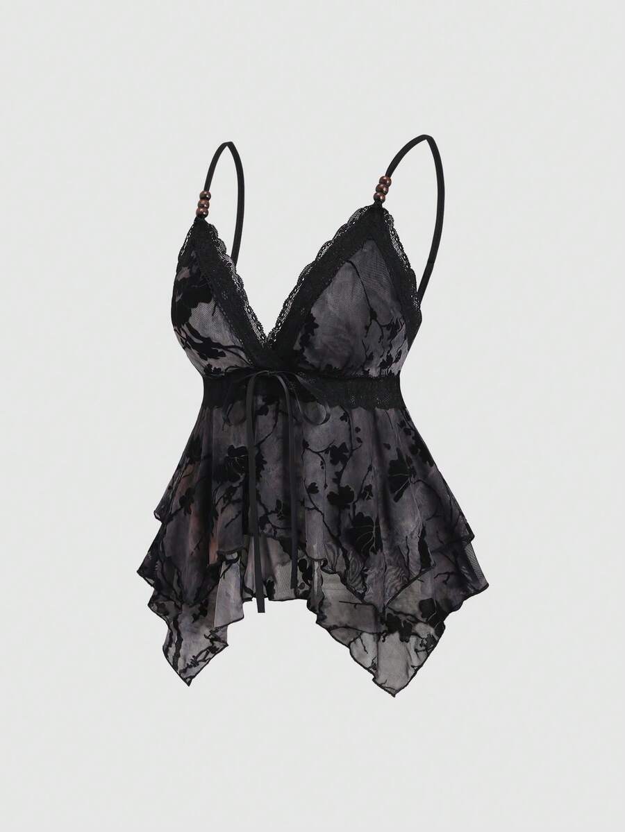 Women's black spaghetti strap tank top featuring contrast lace details, asymmetric ruffle hem, and slim fit design.