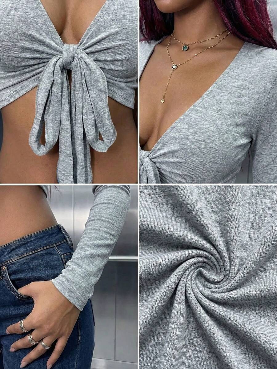 Women's mint blue cropped long sleeve top featuring a deep V-neck and twist knot asymmetrical front hem.