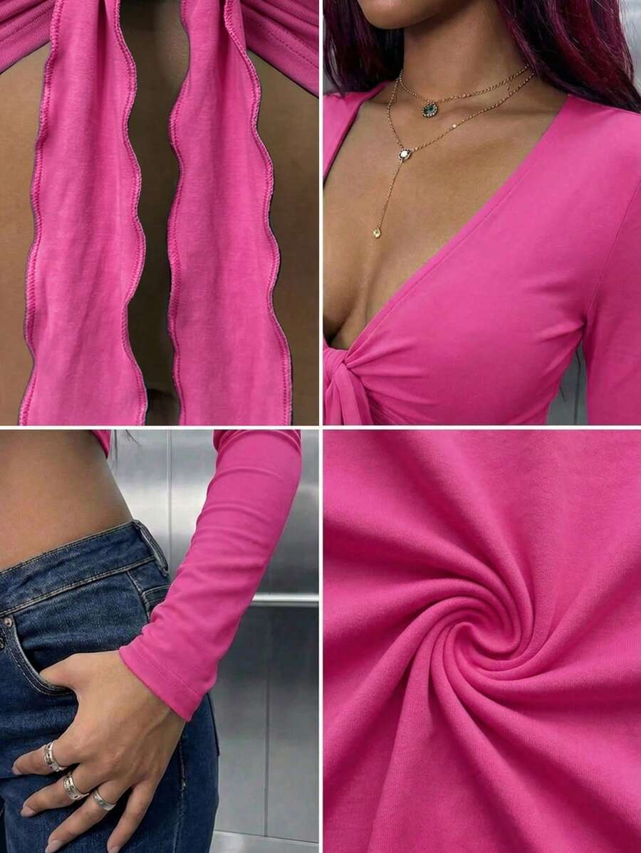 Women's mint blue cropped long sleeve top featuring a deep V-neck and twist knot asymmetrical front hem.