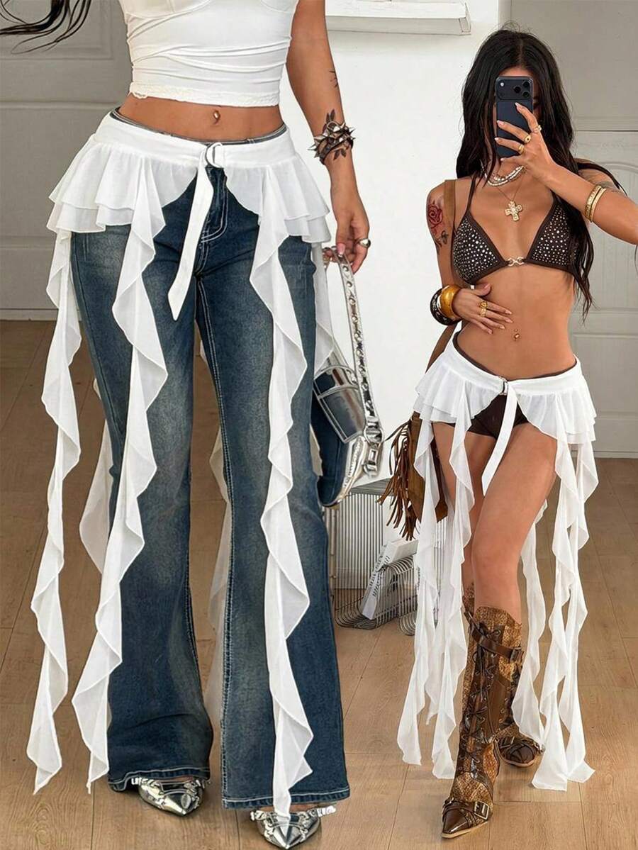 Women's black semi-sheer lace asymmetrical skirt with fringe details, contrast lace, low waist, and ruffle hem for beach, party, concert, or festival outfits.