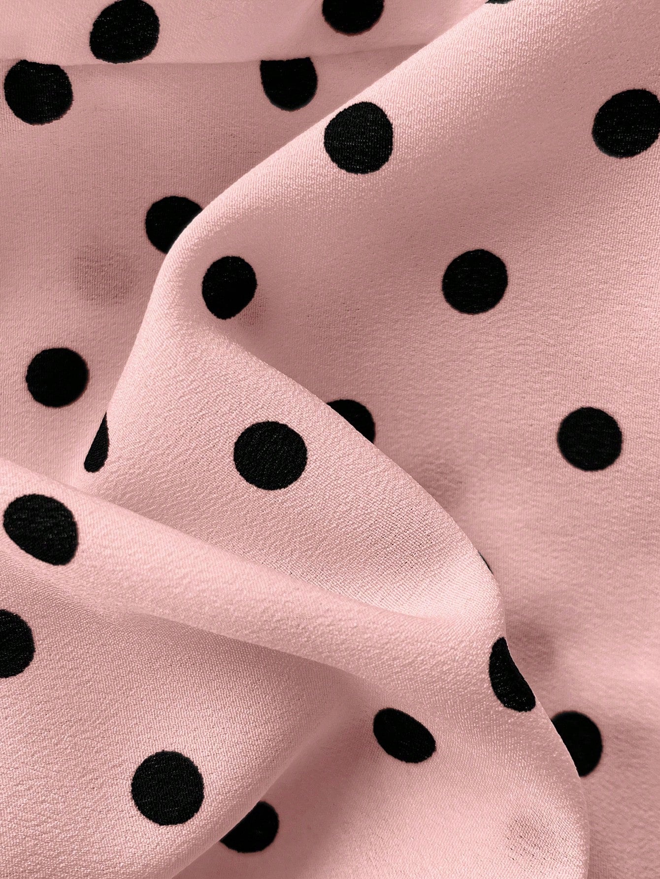 Women's polka dot halter camisole with bow bust detail, ruched and shirred design, slim crop fit, and flared ruffle hem.