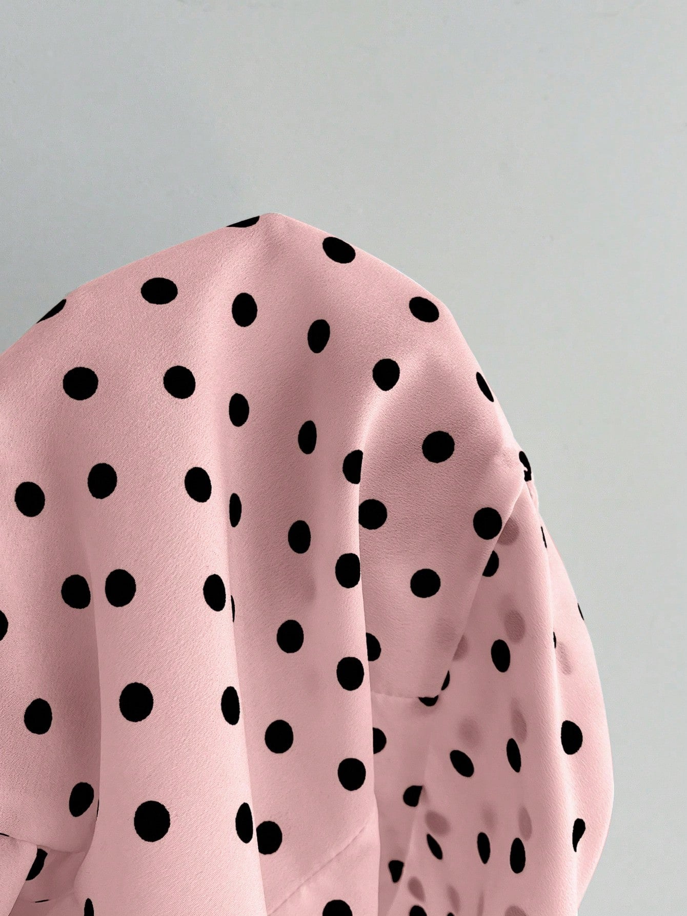 Women's polka dot halter camisole with bow bust detail, ruched and shirred design, slim crop fit, and flared ruffle hem.