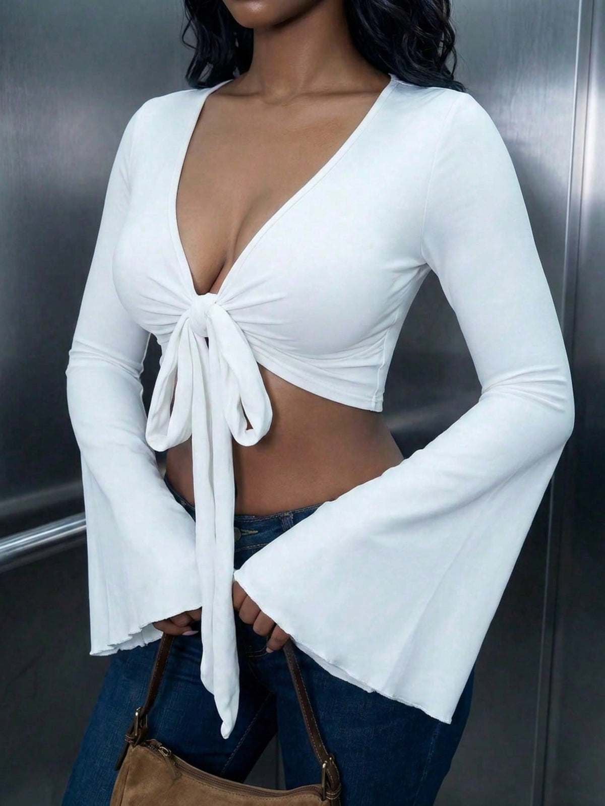 Women's mint blue cropped long sleeve top featuring a deep V-neck and twist knot asymmetrical front hem.