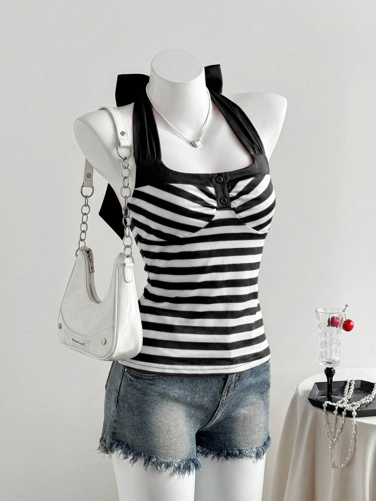 Women's multicolor striped halter top featuring a bow detail and slim fit design.