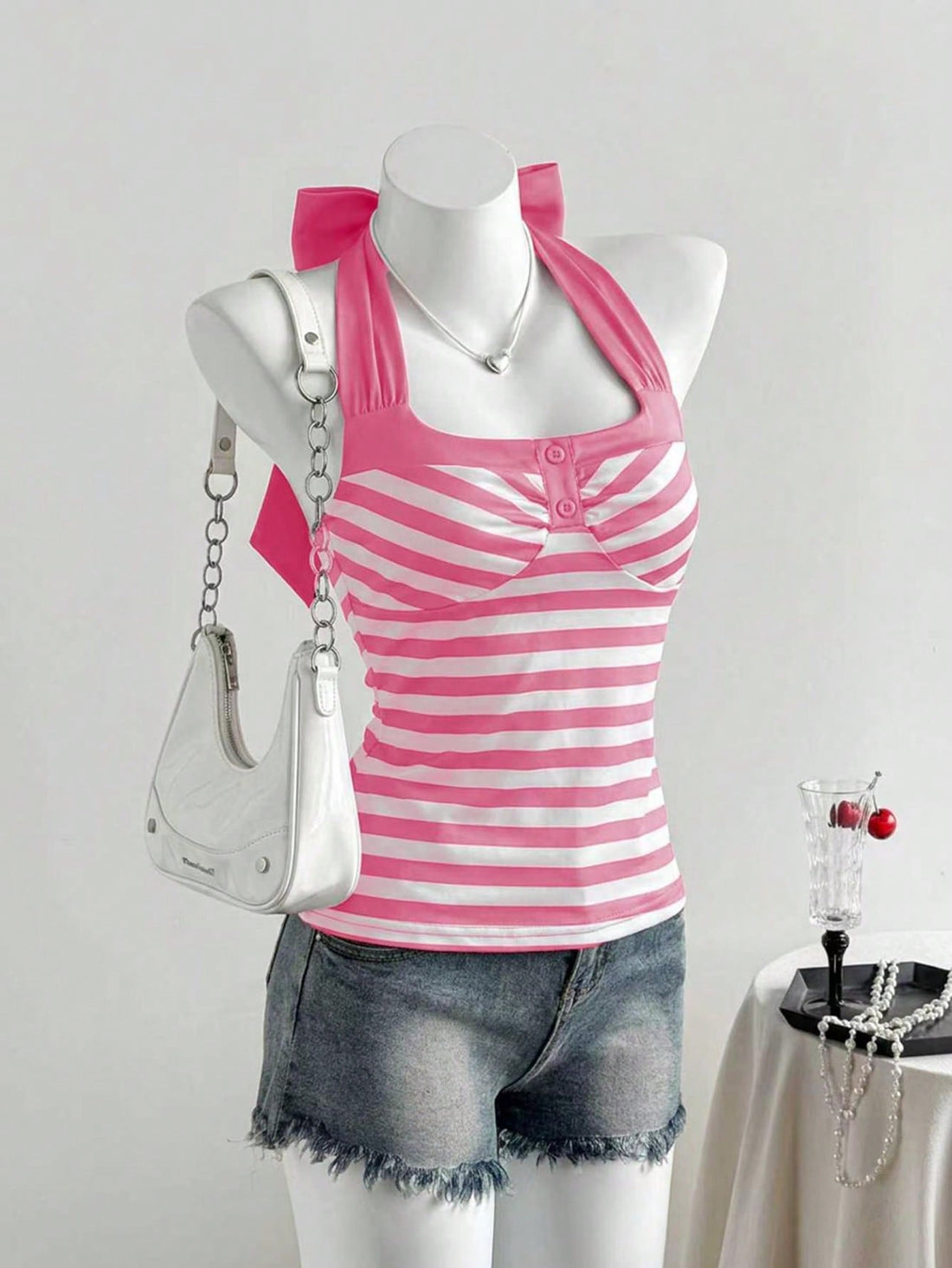 Women's multicolor striped halter top featuring a bow detail and slim fit design.
