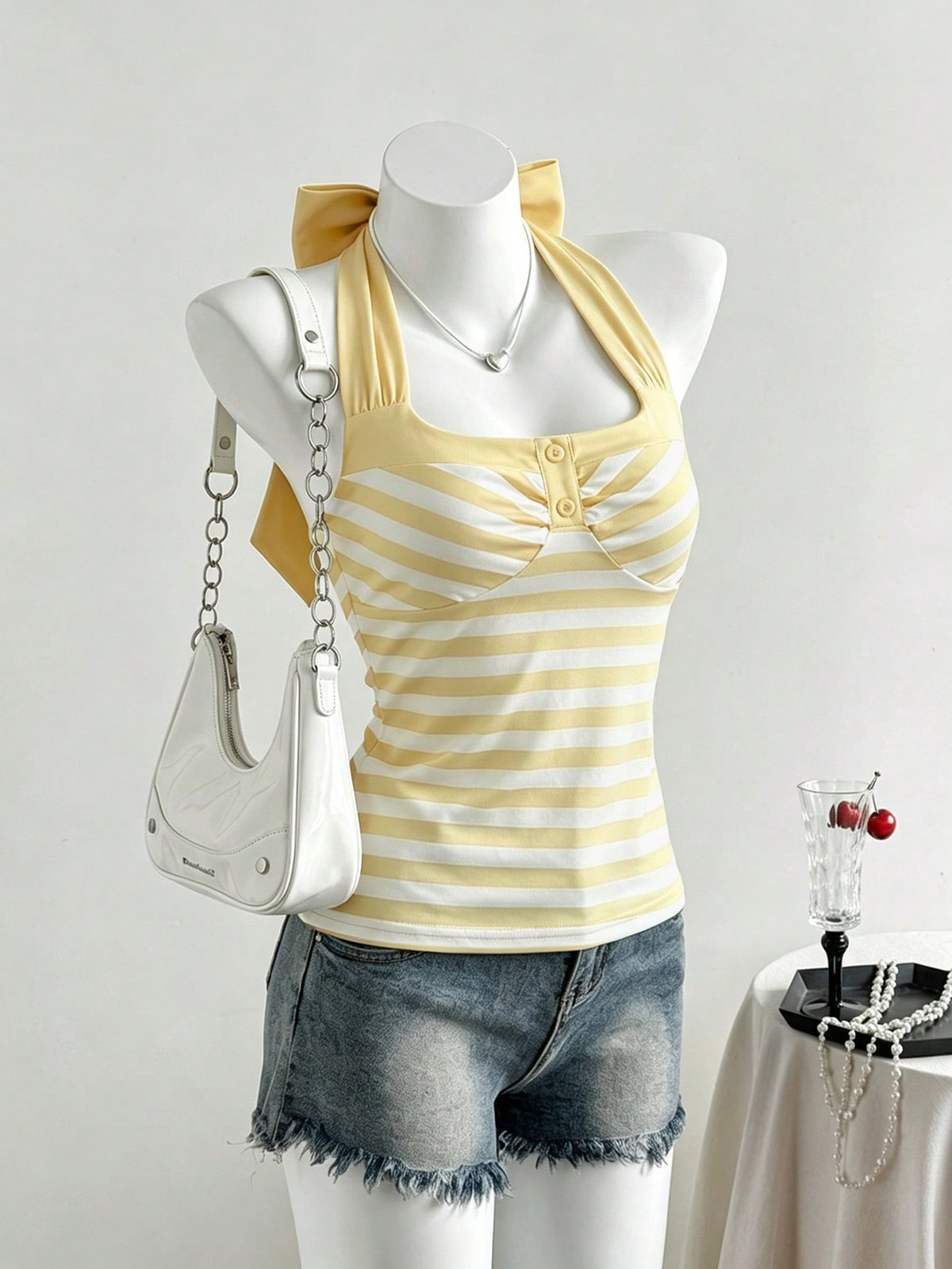 Women's multicolor striped halter top featuring a bow detail and slim fit design.