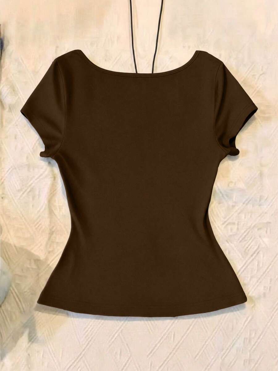 Women's polka dot short sleeve raglan t-shirt with a twist front detail and contrast collar.