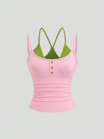 Women's pink colorblock cami tank top featuring spaghetti straps and criss-cross detailing in a slim fit knitted design.