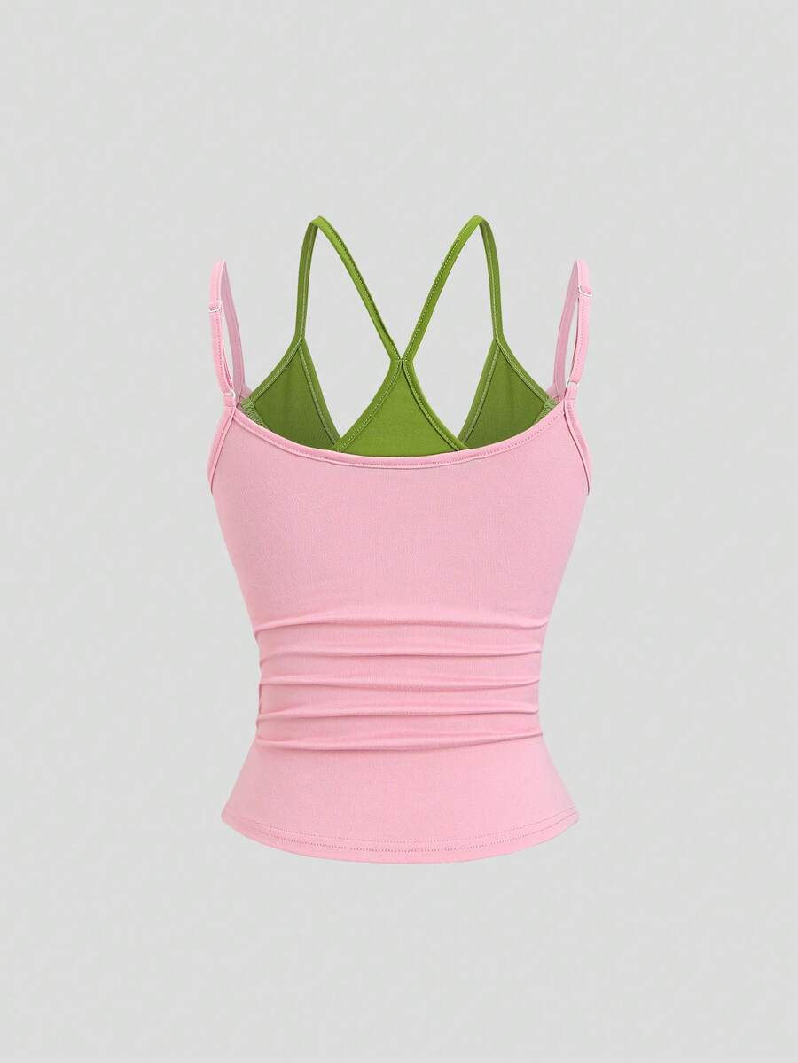 Women's pink colorblock cami tank top featuring spaghetti straps and criss-cross detailing in a slim fit knitted design.