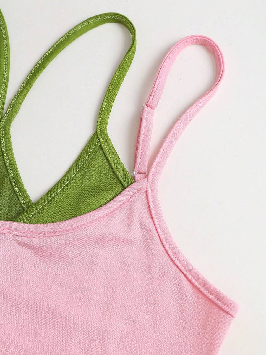 Women's pink colorblock cami tank top featuring spaghetti straps and criss-cross detailing in a slim fit knitted design.