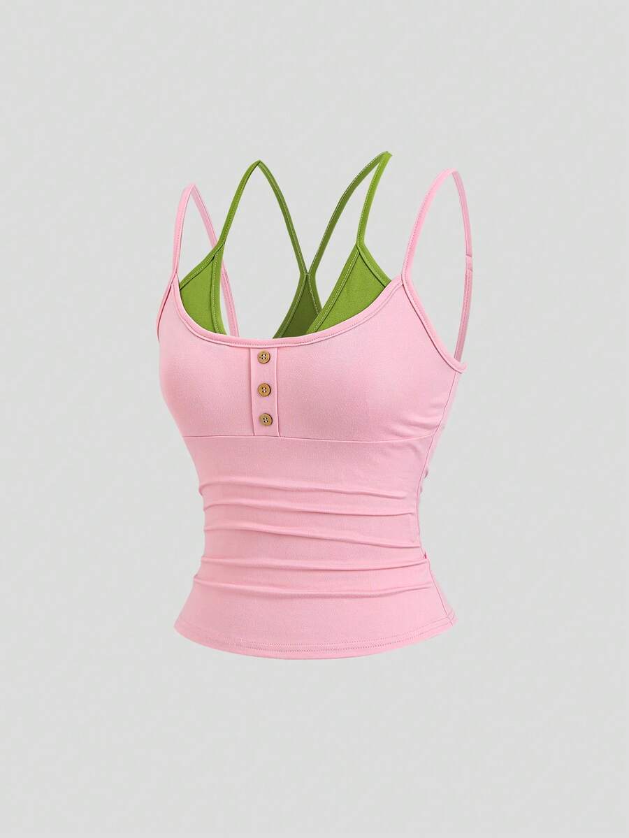 Women's pink colorblock cami tank top featuring spaghetti straps and criss-cross detailing in a slim fit knitted design.