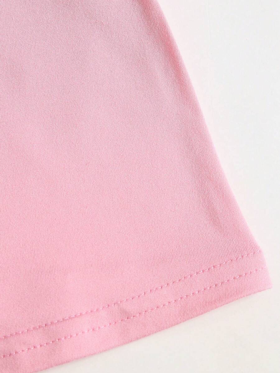 Women's pink colorblock cami tank top featuring spaghetti straps and criss-cross detailing in a slim fit knitted design.
