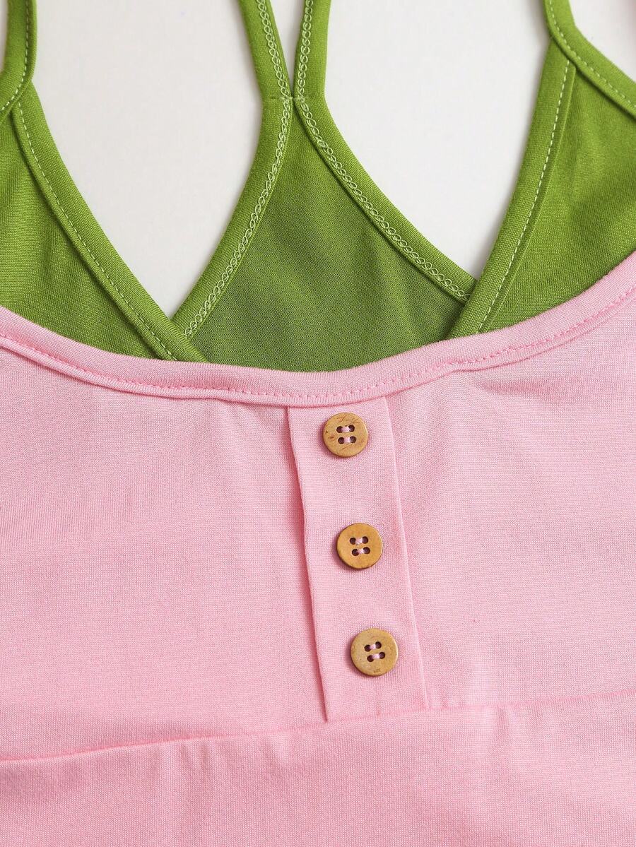 Women's pink colorblock cami tank top featuring spaghetti straps and criss-cross detailing in a slim fit knitted design.