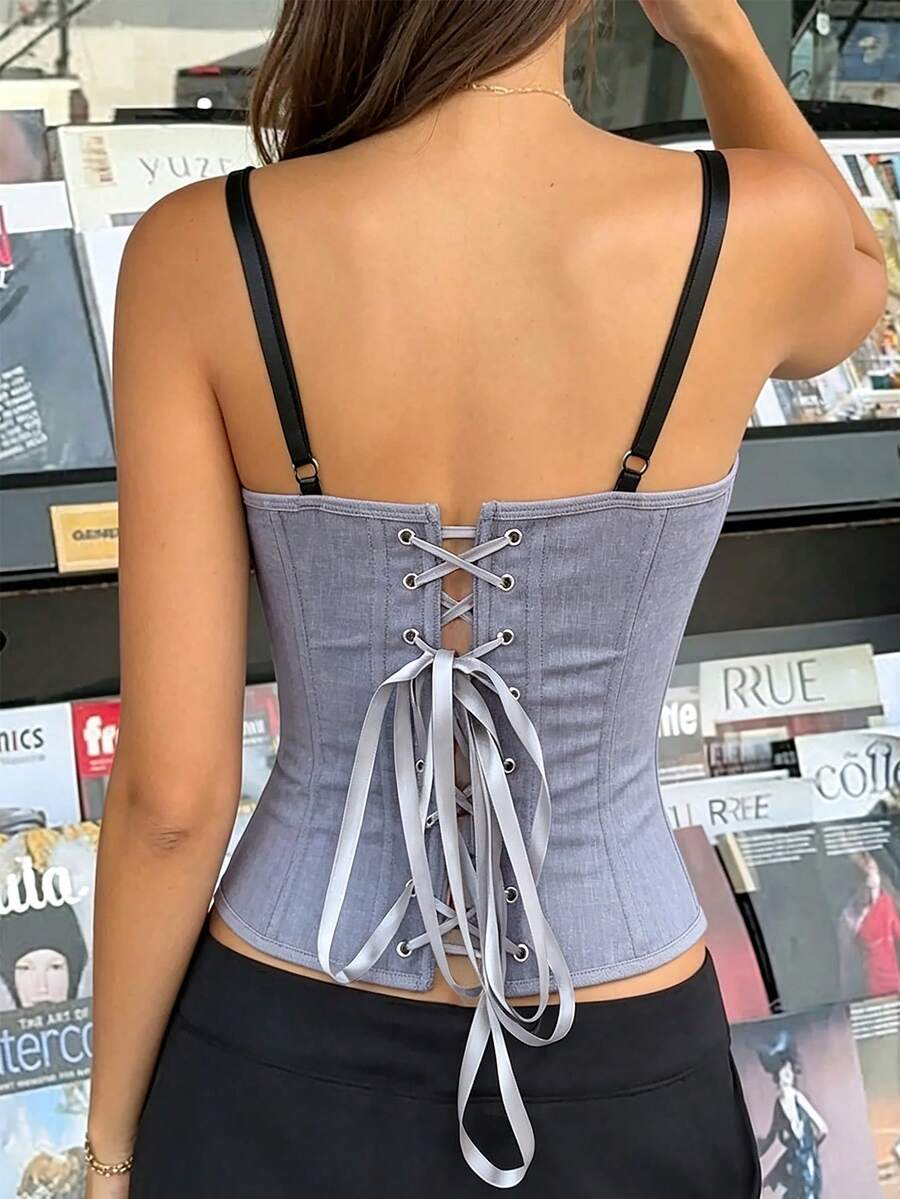 Women's light grey boned corset top featuring lace-up cargo details and spaghetti straps.