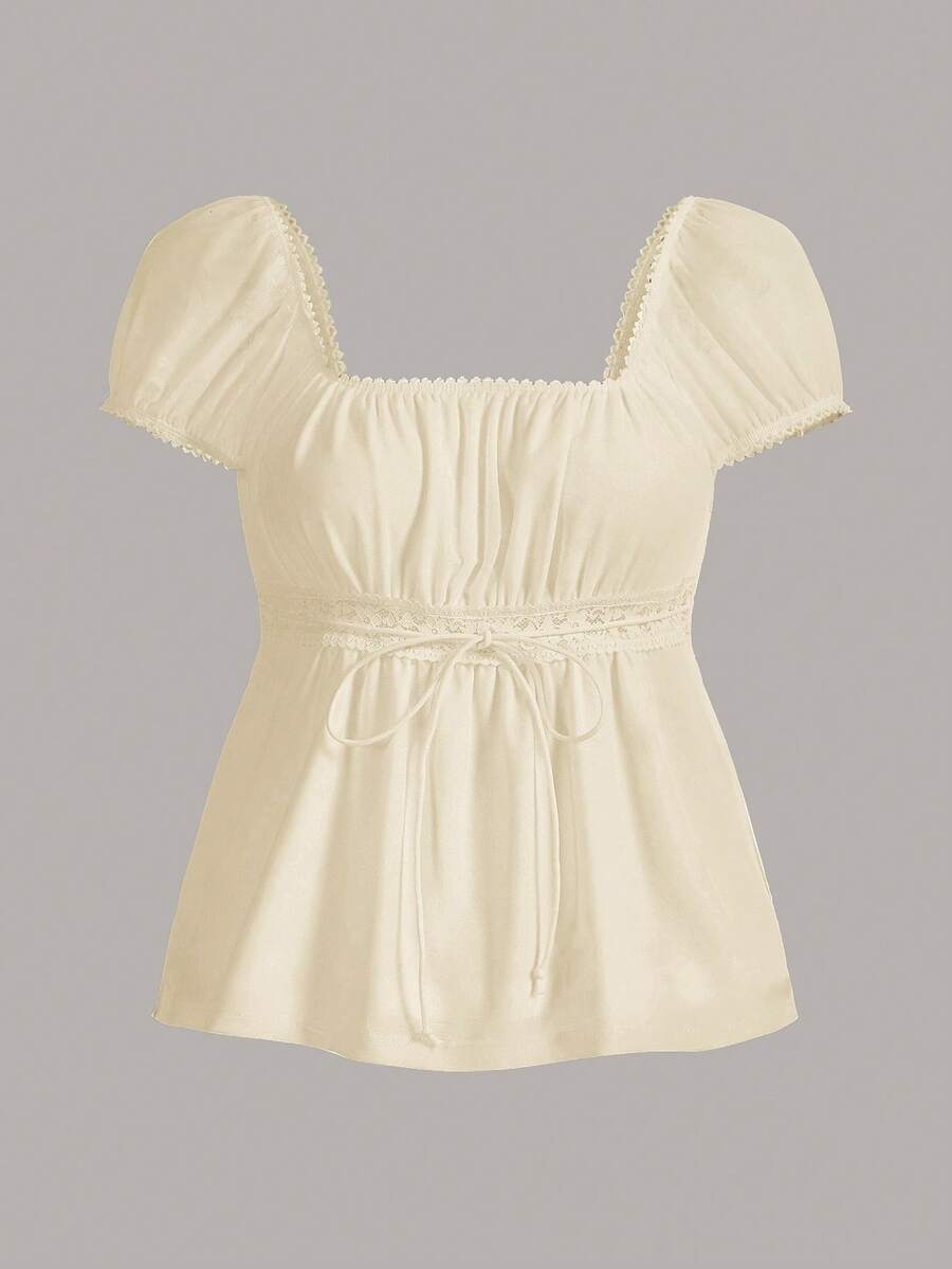 Women's black short puff sleeve top featuring a square neckline, ruched bust detail, and flared ruffle hem.