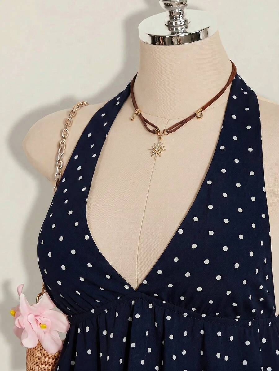 Women's polka dot print halter camisole with backless knot detail, ruched front, slim fit, and flared ruffle hem