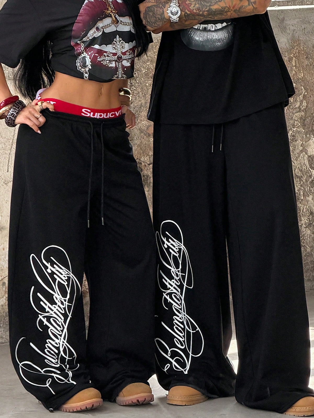 Women's loose fit wide leg graphic sweatpants in light grey with an elastic drawstring waistband