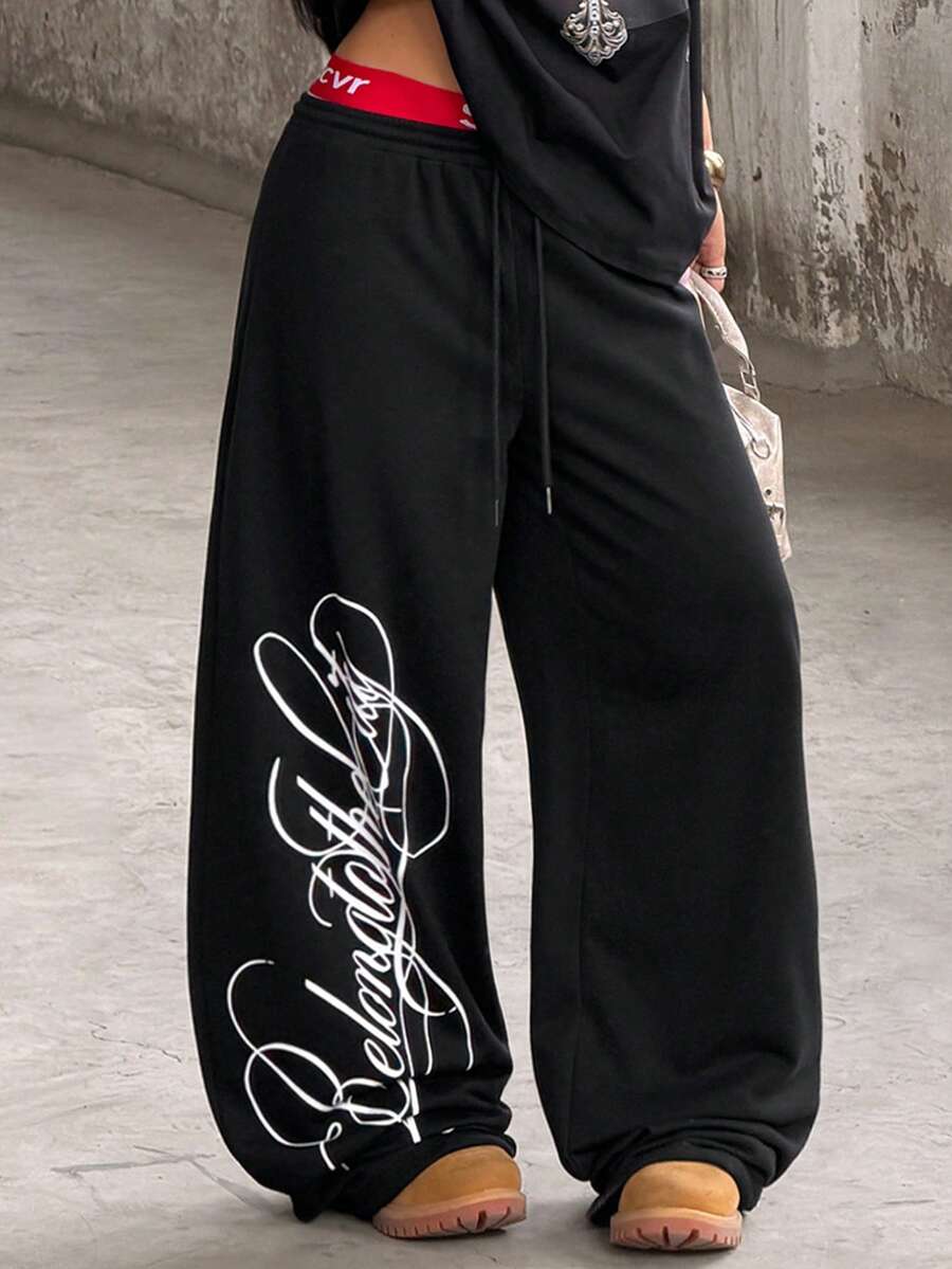 Women's loose fit wide leg graphic sweatpants in light grey with an elastic drawstring waistband