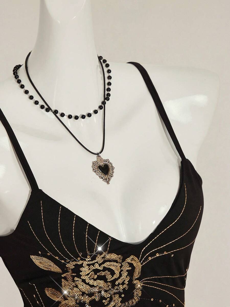Women's floral embroidered sequin camisole top with thin spaghetti straps and a slim fit design.